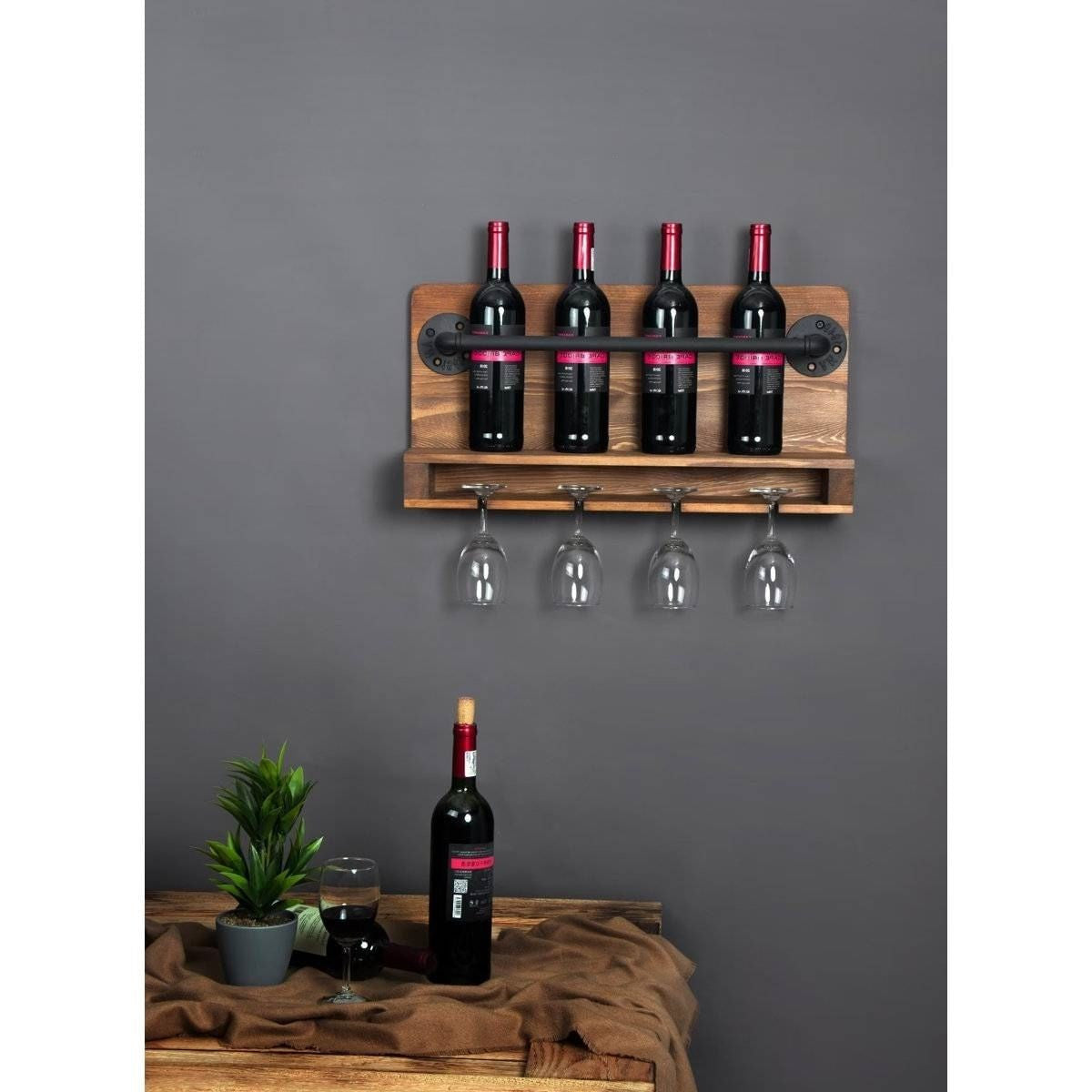 Wooden wall-mounted wine rack with bottles and glasses against a gray wall.