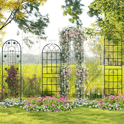 Decorative metal garden arches with floral arrangements in a garden setting.