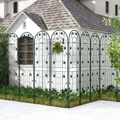 Decorative metal fence in front of a white building with a gray roof.