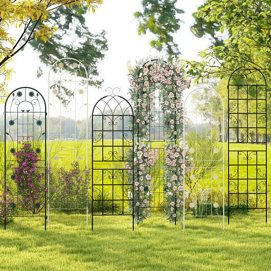 Decorative metal garden arches with floral arrangements in a garden setting.