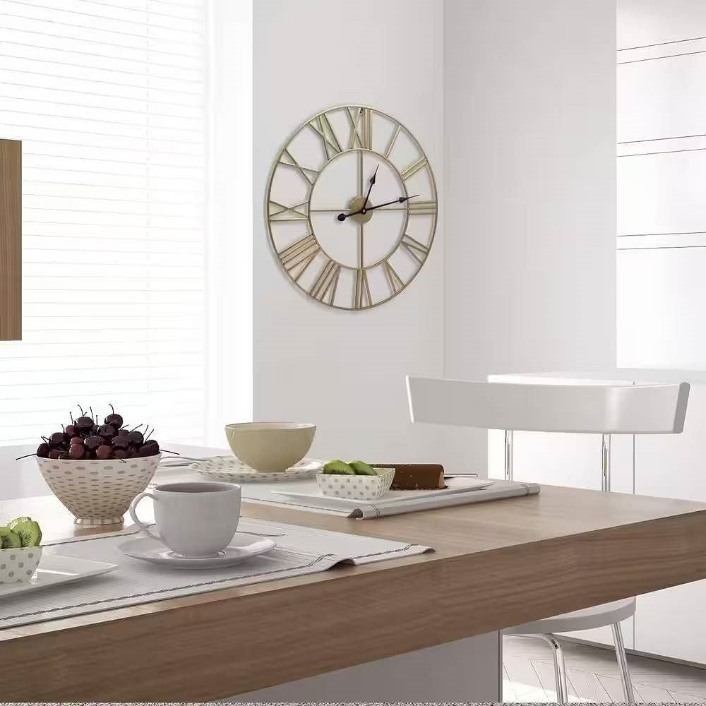 Dining room with a wooden table, clock on the wall, and various items on the table.