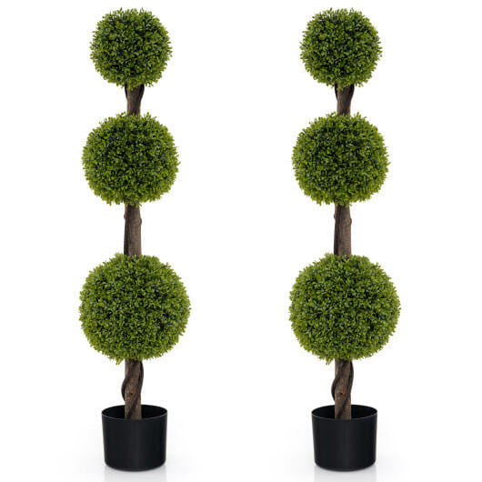 Two artificial topiary trees with spherical green balls on a white background