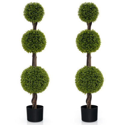 Two artificial topiary trees with spherical green balls on a white background