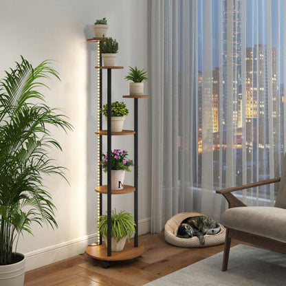 Tall wooden plant stand with plants in a room with a cityscape view.
