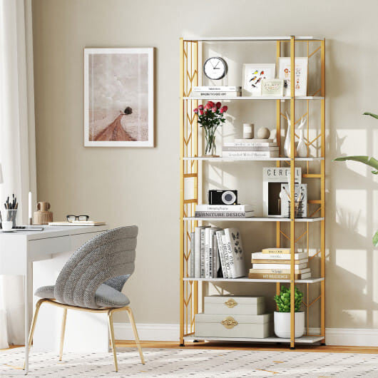 Gold bookshelf with decorative items in a home office setting