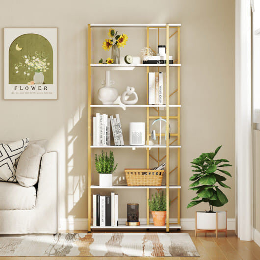 Bookshelf in a living room with decor items against a beige wall.