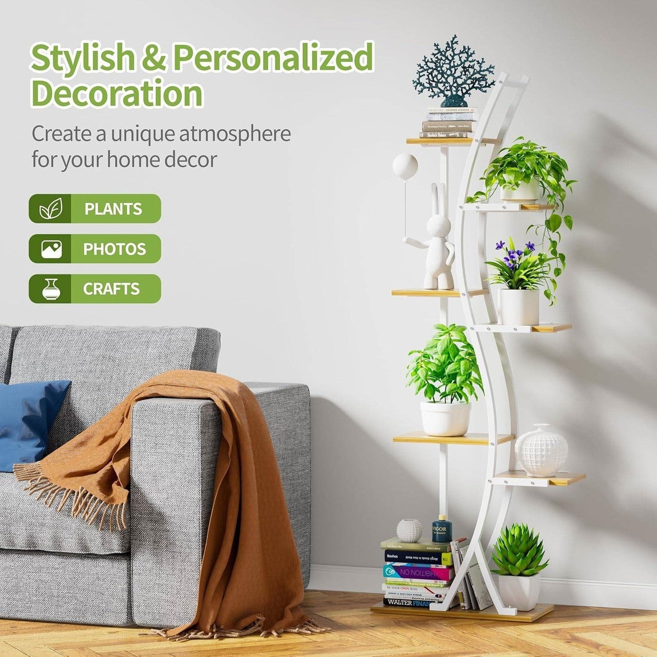 White circular shelf with plants, books, and decor items against a gray wall.