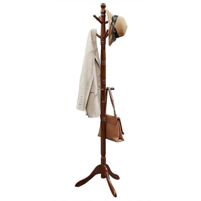 Wooden coat rack with a beige coat, brown bag, and straw hat on a white background