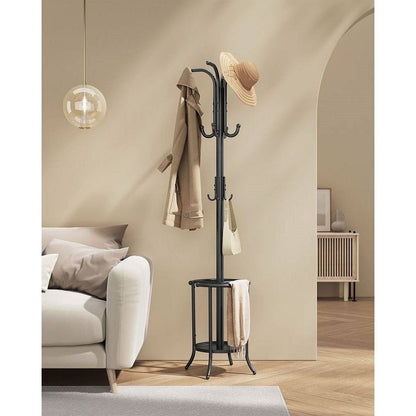 Black coat rack with a hat and coats in a living room setting.