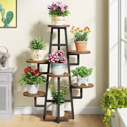 Ladder-style plant stand with various potted plants in a room setting.