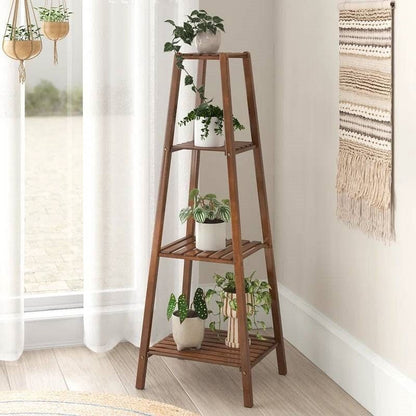 Wooden plant stand with potted plants in a room with a window and wall art.