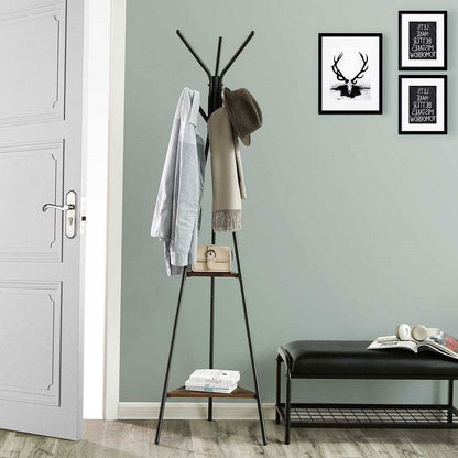 Coat rack with clothes against a light gray wall with framed pictures.