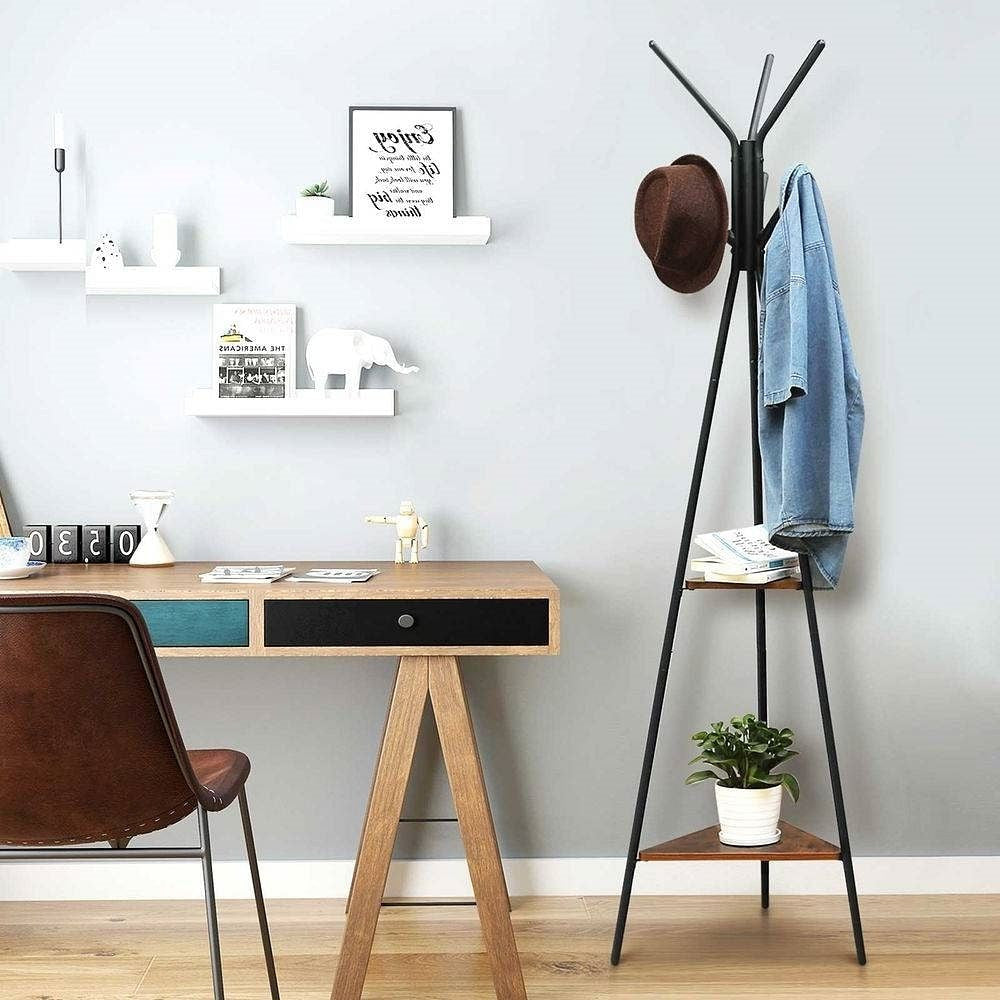 Home office with wooden desk, chair, coat rack, and shelves.