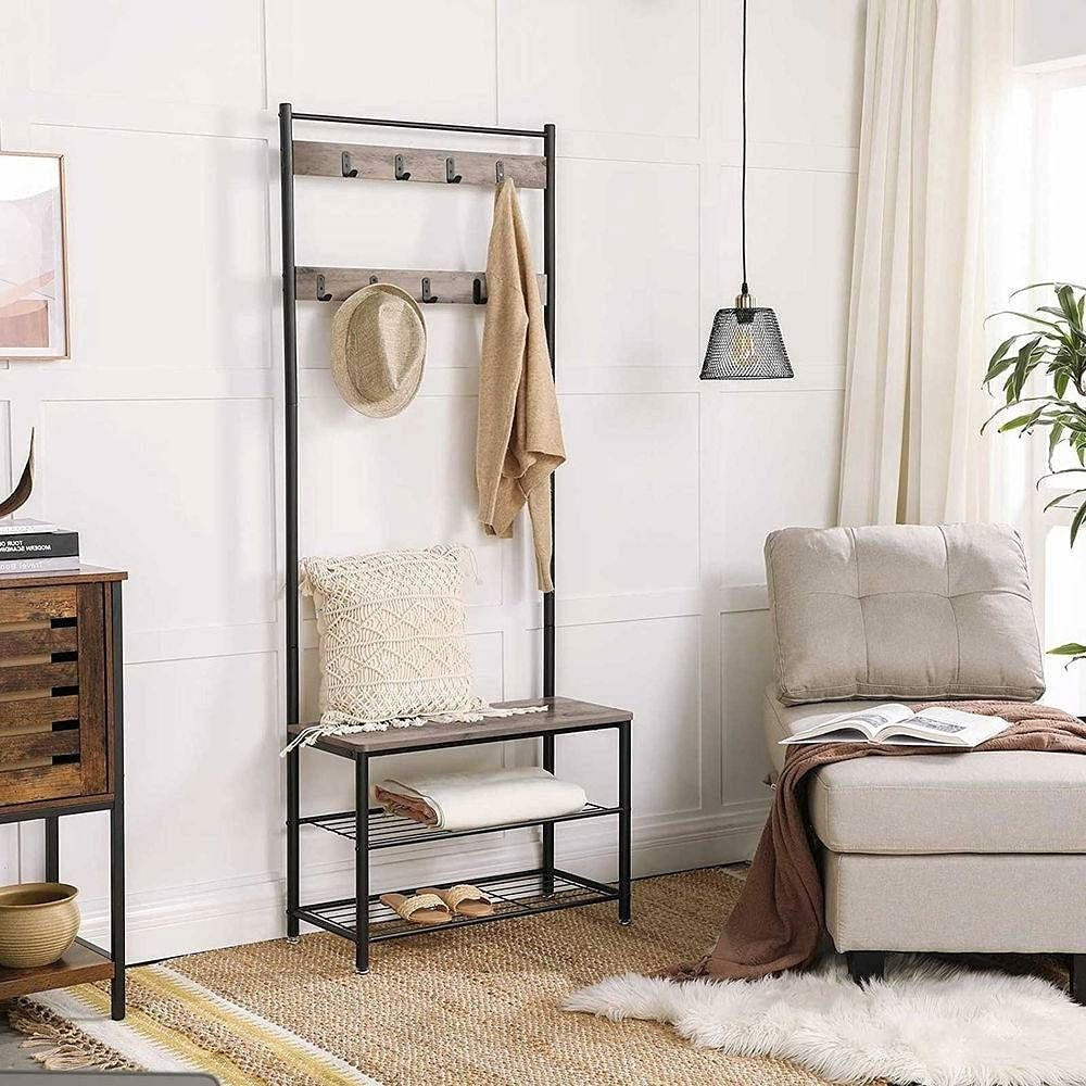 Entryway with coat rack, bench, and seating area in a home setting.