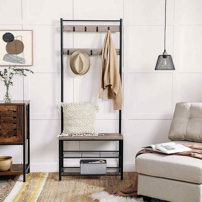 Entryway with a black metal rack, bench, and various items on a white wall background.