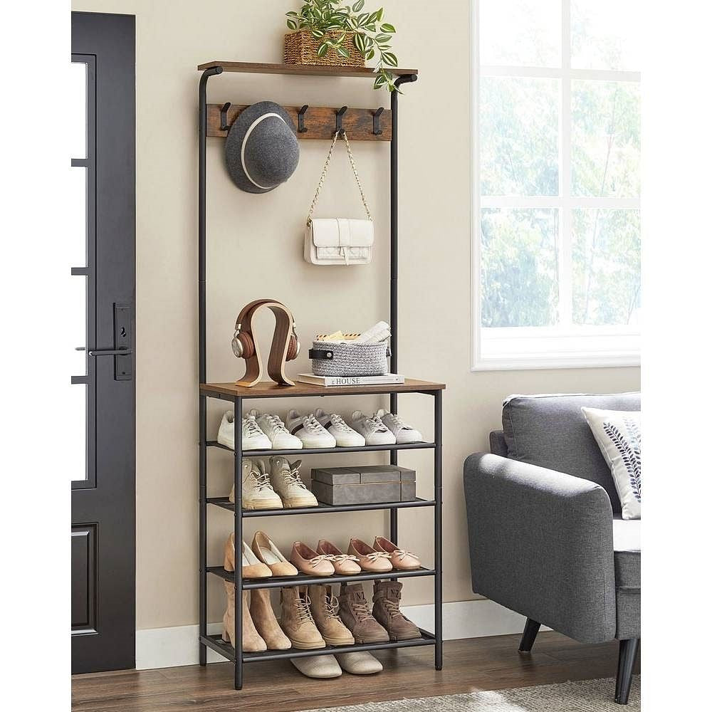 Shoe rack with shoes and accessories in a room with a gray armchair and window.