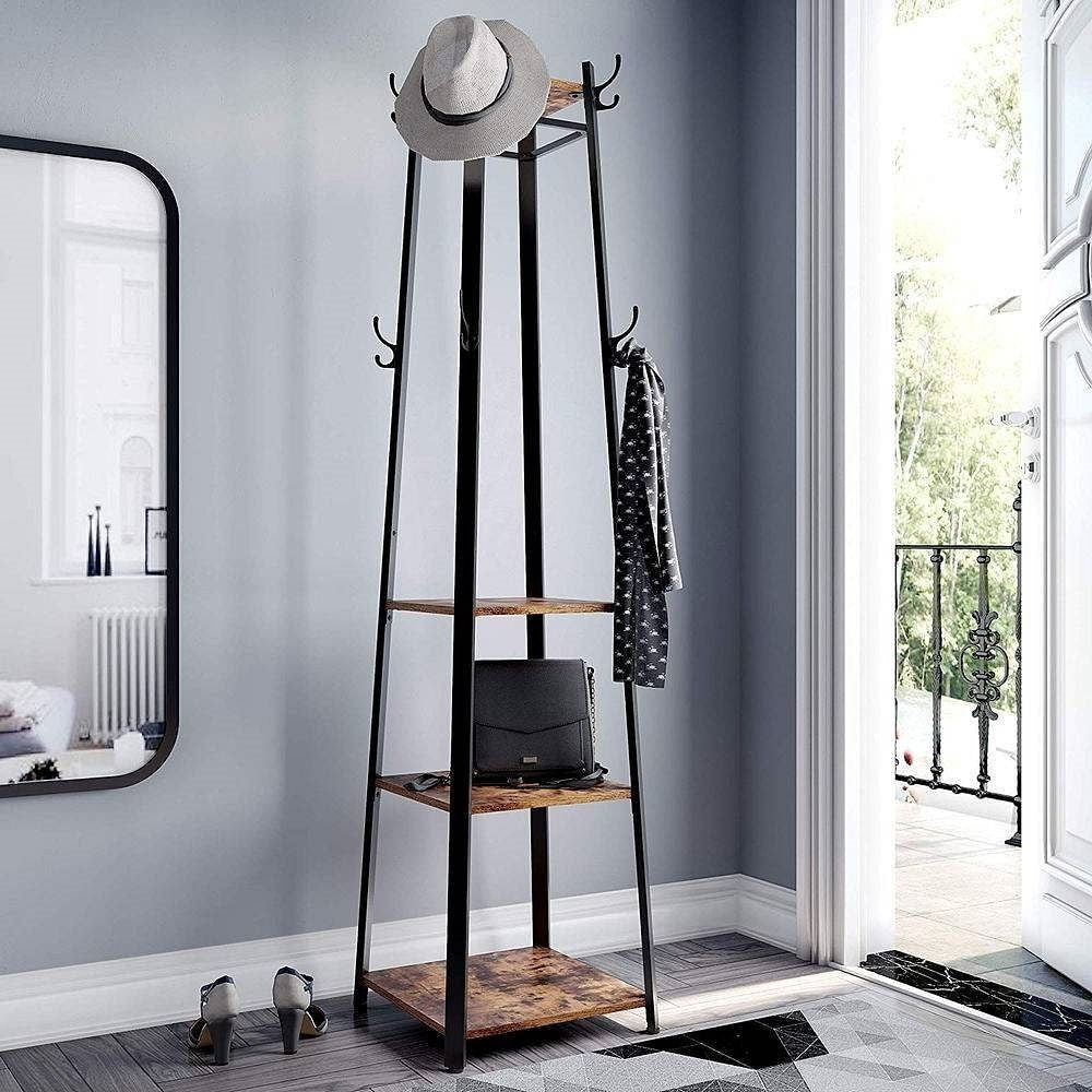 Coat rack with shelves in a room with a mirror and open door.