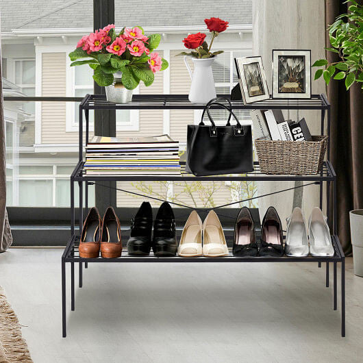 Shoe rack with shoes, handbag, and decor items in a home setting