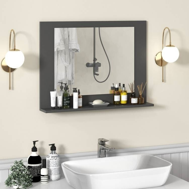 Bathroom setup with a mirror, shelves, and various toiletries on a neutral wall.