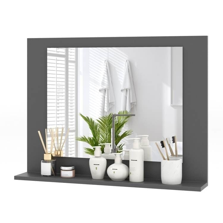 Gray-framed mirror with decorative items on a shelf in a bathroom setting