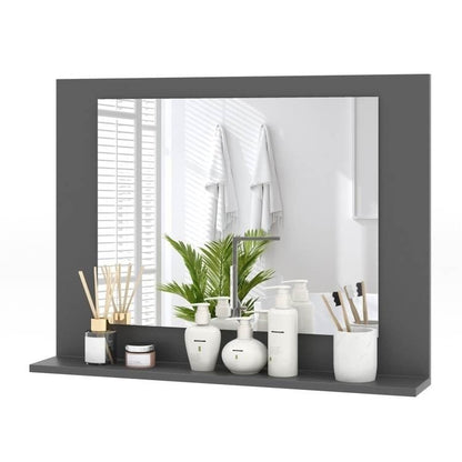 Gray-framed mirror with decorative items on a shelf in a bathroom setting