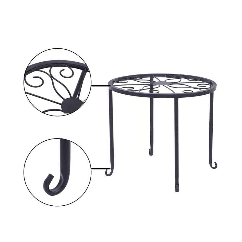 Black metal round table with decorative legs on a white background