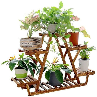 Wooden plant stand with multiple potted plants on a white background