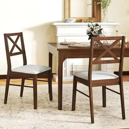 Dining table with two wooden chairs in a well-lit room.