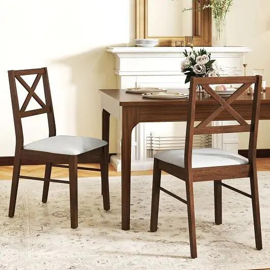 Dining table with two wooden chairs in a well-lit room.